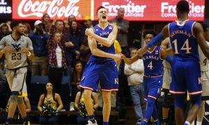In an interesting match, the seventh-ranked Jayhawks team has defeated the Kansas State wildcat by 70-56 points to retain sole possession of the Big 12 lead. During the fast half, Kansas shot the ball great against Kansas State but they played poorly in during the second half. But soon the team rectified their gameplay style. Svi Mykhailiuk had 22 points to lead four Kansas players in double-figures. Apart from that, Devonte Graham scored 16 points, and Malik Newman scored 13 for Kansas Jayhawks. It was like they all were celebrating the Kansas Day holiday. It was their seventh straight victory over Kansas State. Winning team coach Bill Self said, “If you’re going to be up 13 on the road, have 12 turnovers and go 6 for 13 from the foul line, you wouldn’t think that would be the case.” However, the team managed to keep the lead and win the match by performing good in first half and second half. As per the report Kansas’s forward Mitch Lightfoot suffered from injury as he hit his head hard on the floor while taking charge and after that, for several minutes he stayed down on the floor. But after some time, Lightfoot stood up on his leg and walked off with help. Coach Self said “They said he was fine. I guess he passed the protocol.” Dean Wade who had scored 20 points and eight rebounds said “I don’t think we were in rhythm the whole game. We didn’t get inside enough – there’s a lot of different things that happened that we could have done better.” Bruce Weber, the coach of Kansas State, said “I told the guys we had to play better than we did in Lawrence.” He further stated that Kansas is a great team and they have a better understanding of themselves. The zone defense slowed them down, Graham stated.