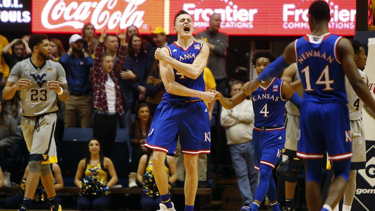 In an interesting match, the seventh-ranked Jayhawks team has defeated the Kansas State wildcat by 70-56 points to retain sole possession of the Big 12 lead. During the fast half, Kansas shot the ball great against Kansas State but they played poorly in during the second half. But soon the team rectified their gameplay style. Svi Mykhailiuk had 22 points to lead four Kansas players in double-figures. Apart from that, Devonte Graham scored 16 points, and Malik Newman scored 13 for Kansas Jayhawks. It was like they all were celebrating the Kansas Day holiday. It was their seventh straight victory over Kansas State. Winning team coach Bill Self said, “If you’re going to be up 13 on the road, have 12 turnovers and go 6 for 13 from the foul line, you wouldn’t think that would be the case.” However, the team managed to keep the lead and win the match by performing good in first half and second half. As per the report Kansas’s forward Mitch Lightfoot suffered from injury as he hit his head hard on the floor while taking charge and after that, for several minutes he stayed down on the floor. But after some time, Lightfoot stood up on his leg and walked off with help. Coach Self said “They said he was fine. I guess he passed the protocol.” Dean Wade who had scored 20 points and eight rebounds said “I don’t think we were in rhythm the whole game. We didn’t get inside enough – there’s a lot of different things that happened that we could have done better.” Bruce Weber, the coach of Kansas State, said “I told the guys we had to play better than we did in Lawrence.” He further stated that Kansas is a great team and they have a better understanding of themselves. The zone defense slowed them down, Graham stated.